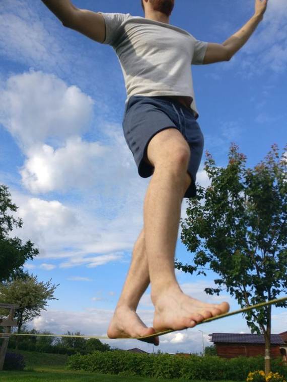 Low-angle view of Martin balancing barefoot on a slackline